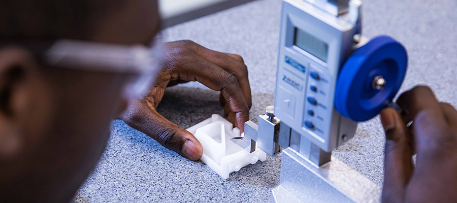 measuring injection molded part in metrology lab