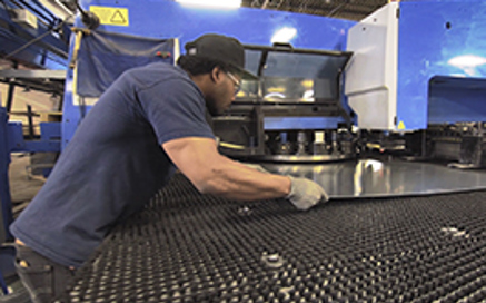 sheet metal technician operating manufacturing machine
