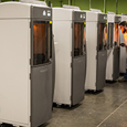 technician examining 3d printed parts in protolabs 3D printers