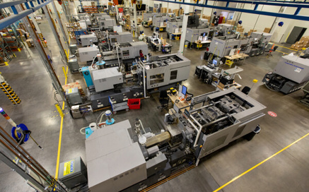 technician examining injection mold