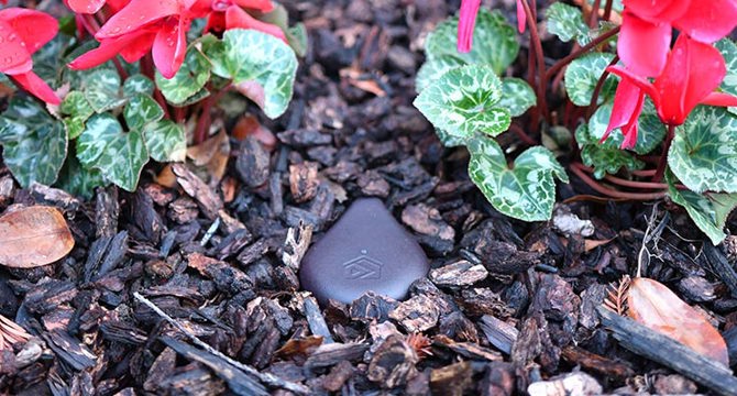 Hand holding a mechanical shaft with gear and bearings.