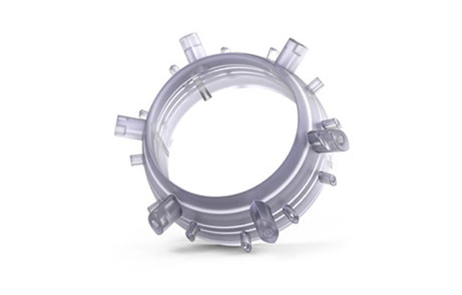 Light gray molded plastic piece with intricate internal structures.