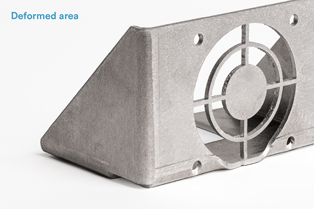 When features are within close proximity to a bend, as with this fan bracket and bottom holes, sheet metal will deform during the bending process.