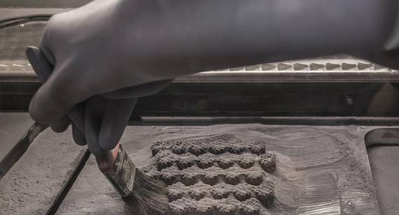 Technician brushes away powder