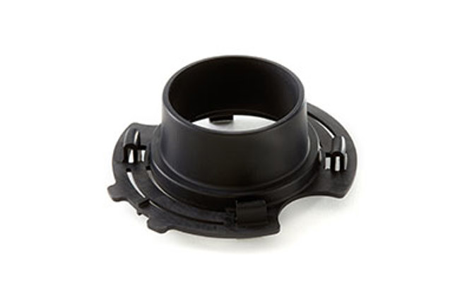 Black round plastic part with twin clasp-like extensions.