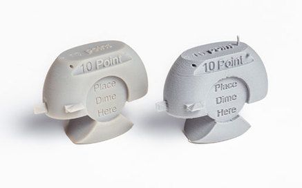 Array of 3D printed parts with intricate details on a blue lit background.