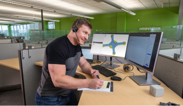 Applications engineer consulting with customer on their part design