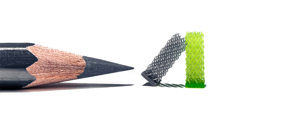 A pencil facing a green curling chip, symbolizing the concept of microfine technology.