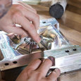 A person inspecting a high-precision aluminum mold in a workshop