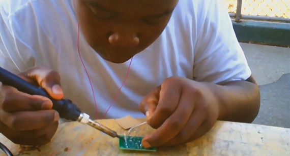 Student solders component for boombox.