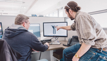 injection molding applications engineers reviewing customer designs