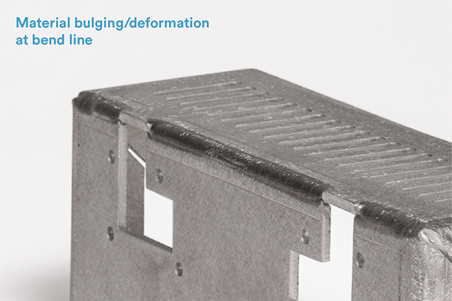 In images A and B (below), the bracket includes two L-shaped cutouts that end along the bend. The material is deformed at the point where the top of each L meets the bend.