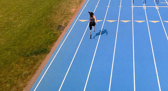 Woman running on a blue track