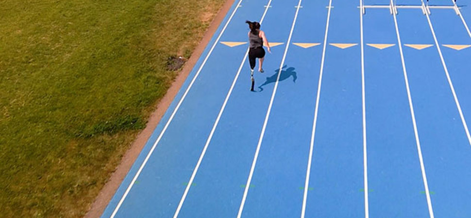Woman running on a blue track